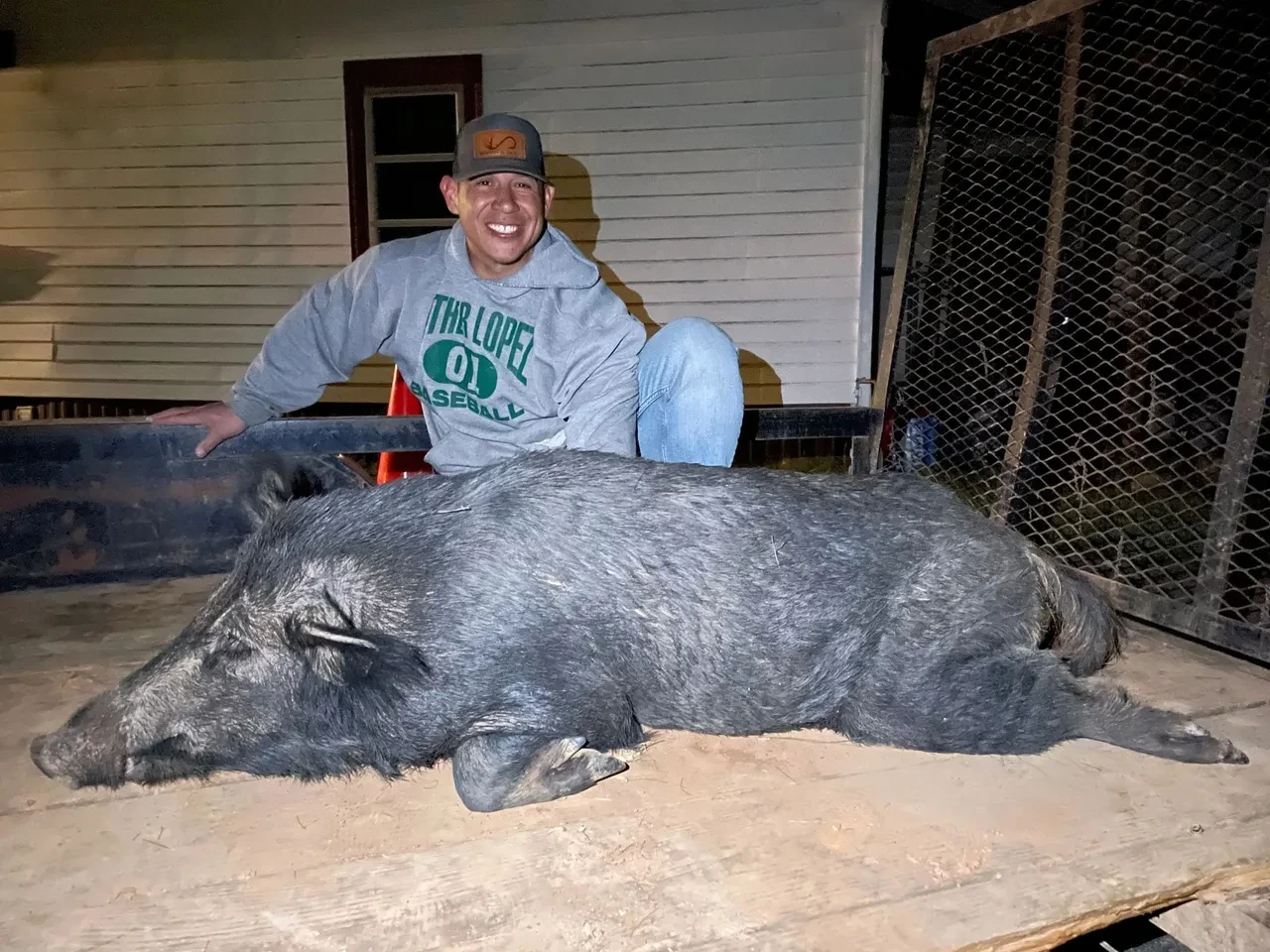 Hunter with a wild boar after a successful night hunt